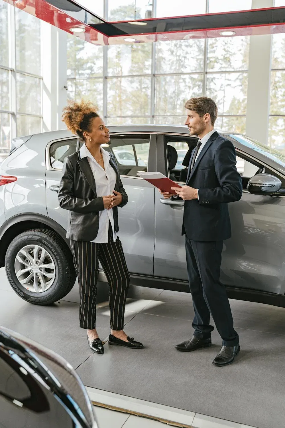 Sales advisor greeting a driver in the showroom